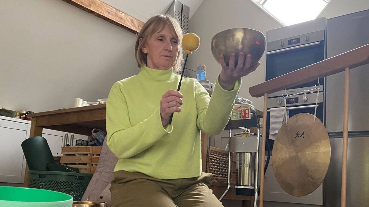 Sound Healing Practitioner playing a Tibetan Bowl
