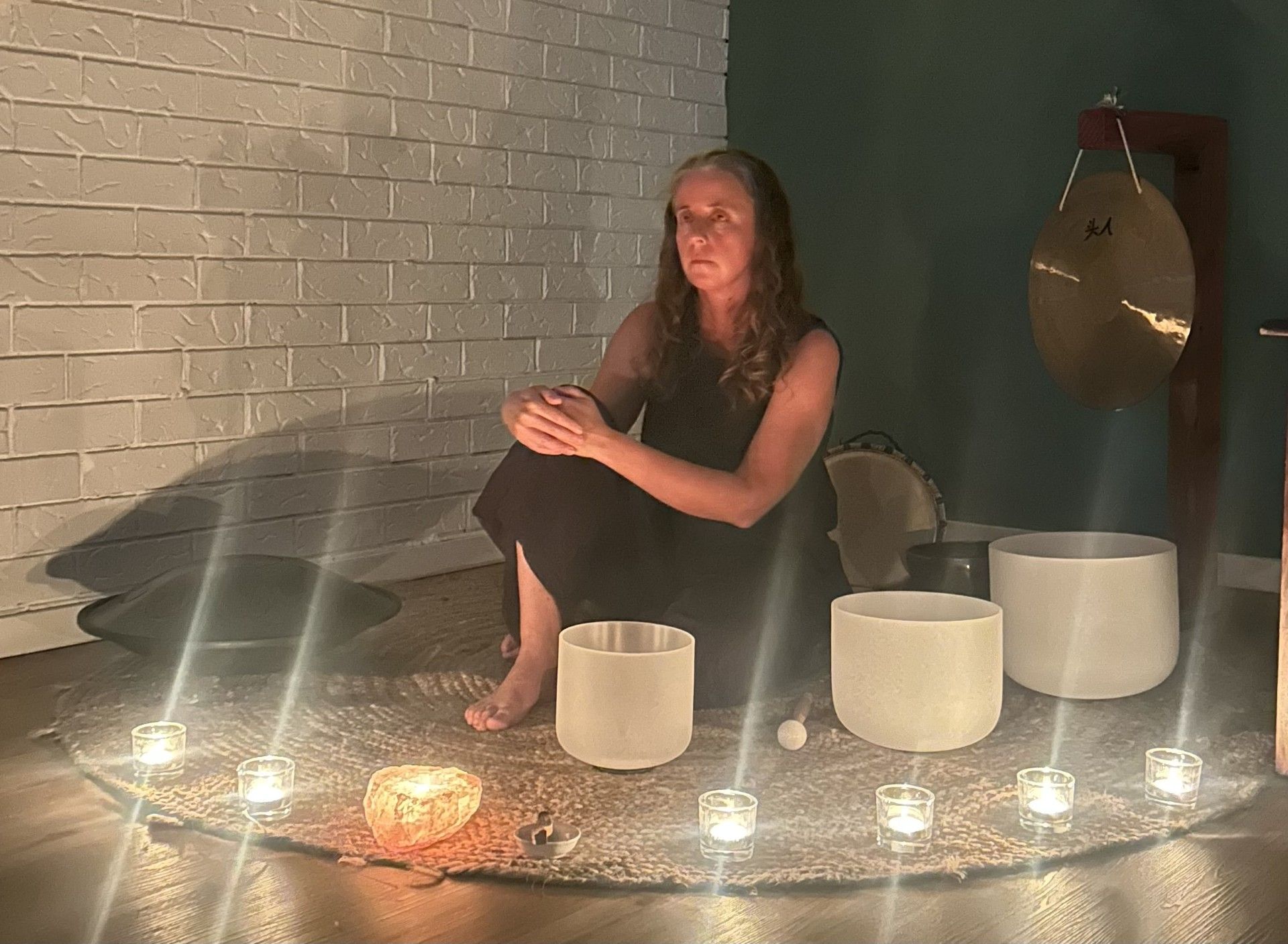Sound Healing Practitioner playing Crystal Singing Bowls