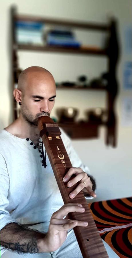 Sound healing practitioner playing a native American style flute
