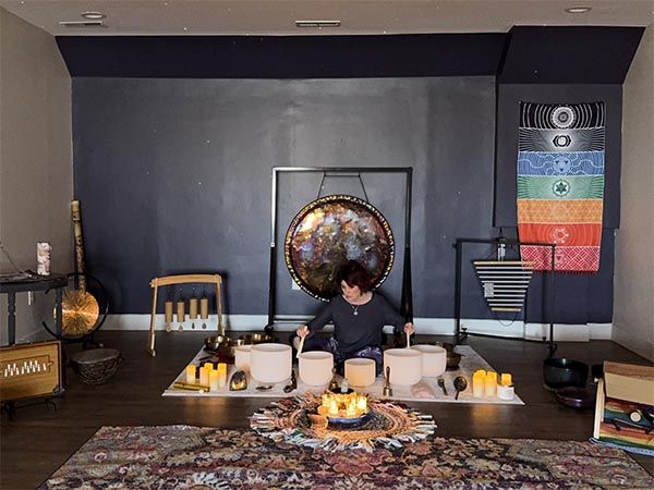 Sound Healing Practitioner playing Crsytal Bowls