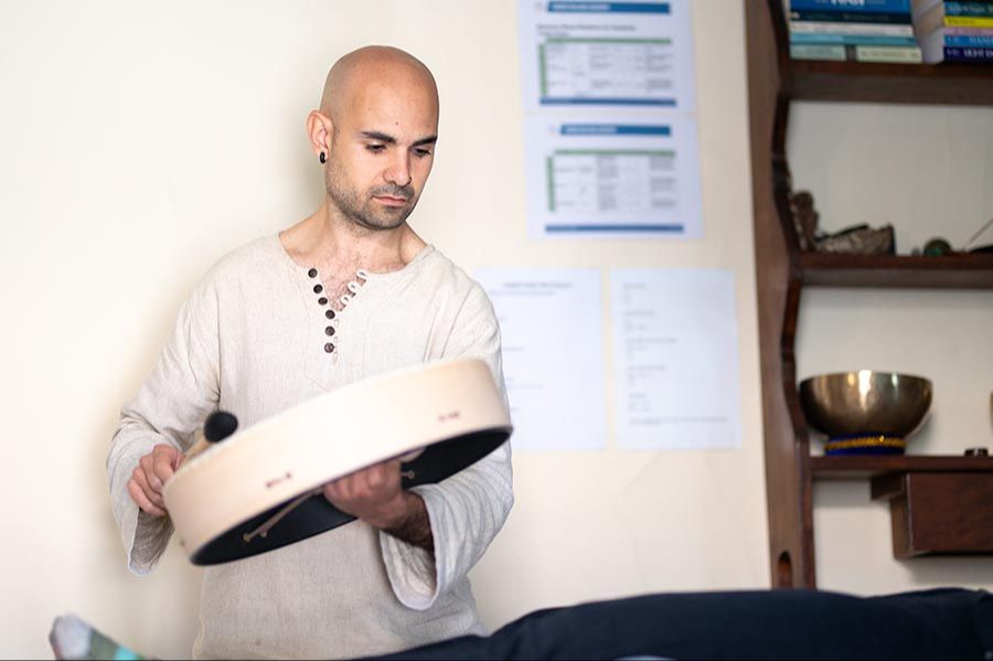 Sound Healing Practitioner playing a drum