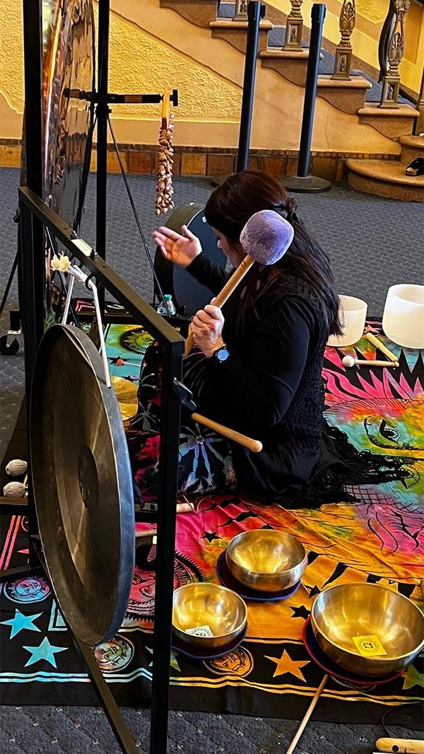 Sound Healing Practitioner playing gongs