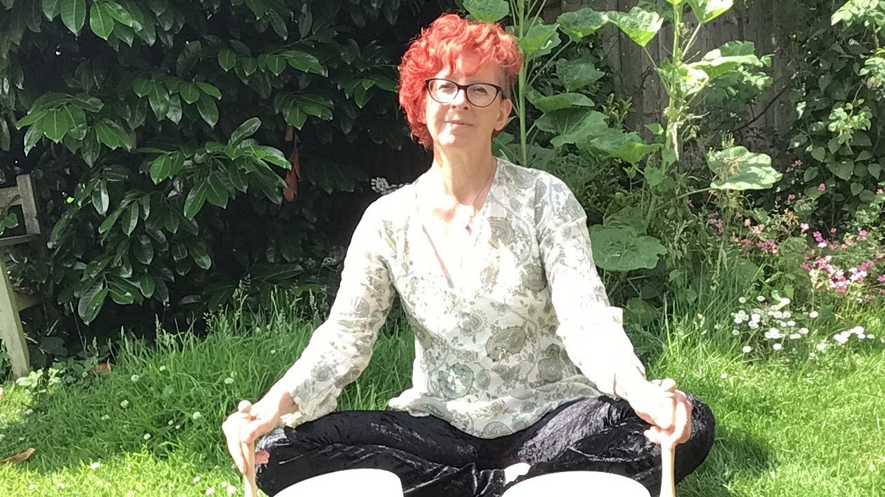 Red headed woman, laying two white crystal singing bowls at the same time in nature