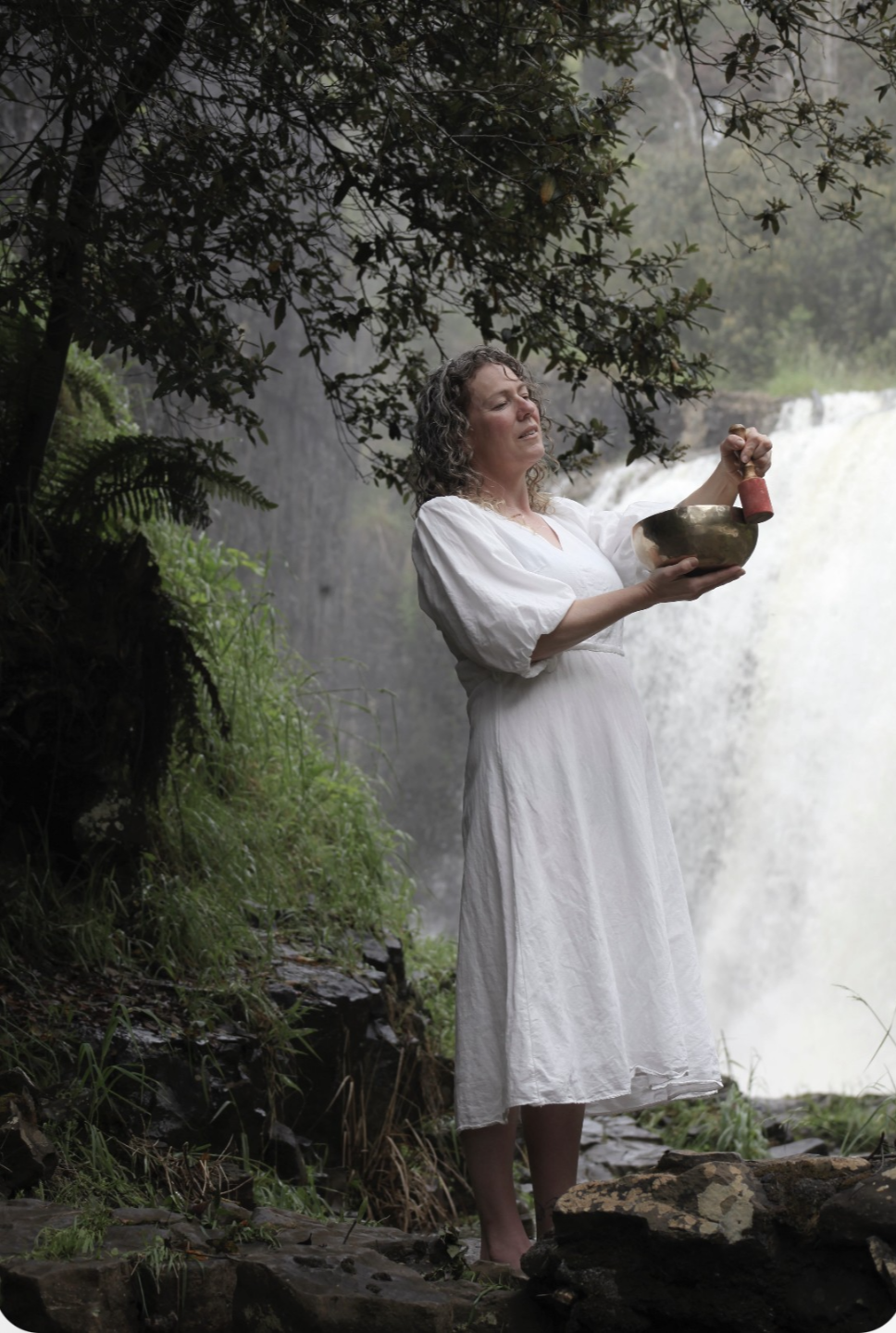 Sound healing practitioner playing a Tibetan Bowl