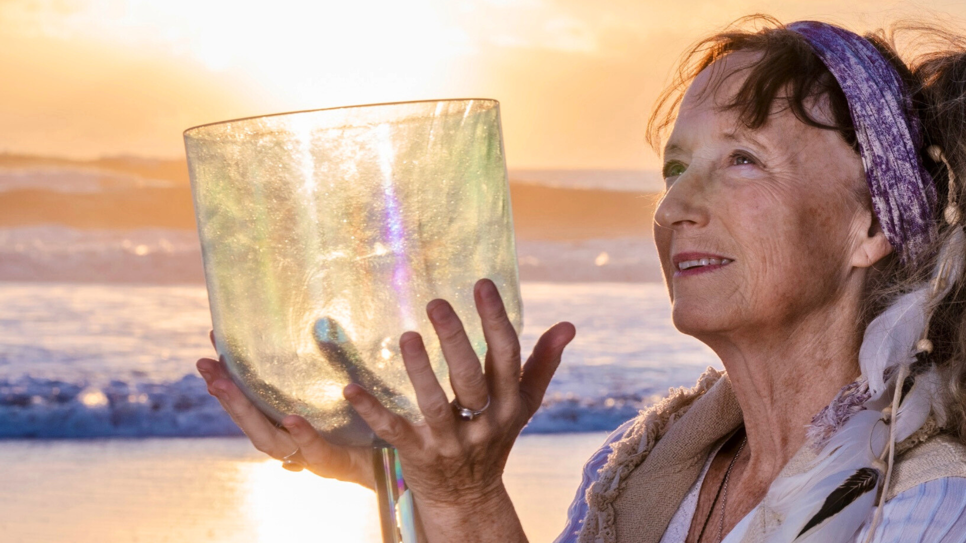 Woman with her palms and arms held upwards in front of a beautiful nature scenery